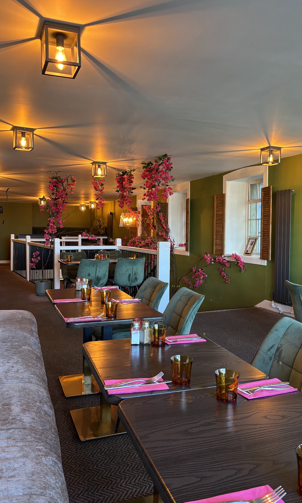 Interior of the Greek Theory restaurant in Falkirk, showing the dining area with warm 
lighting and modern seating 
