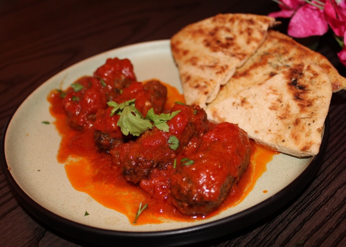 Soft Greek meatballs in a rich tomato sauce with warm pita, served in Greek Theory, Falkirk