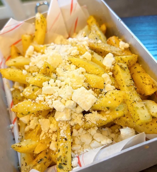 Crispy fries topped with feta cheese, olives, onion, and grilled peppers served in Greek Theory, Falkirk. 